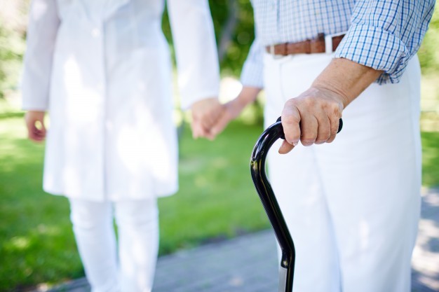 Elderly couple holding hands