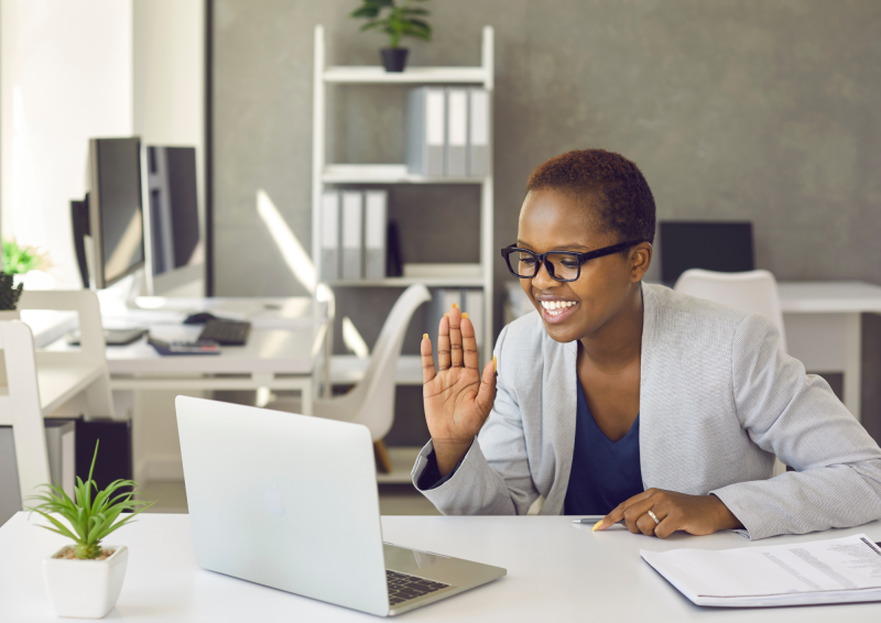 remote worker acknowledging coworker on her laptop screen