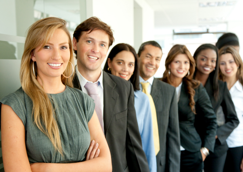 Group of professionals lined up and smiling