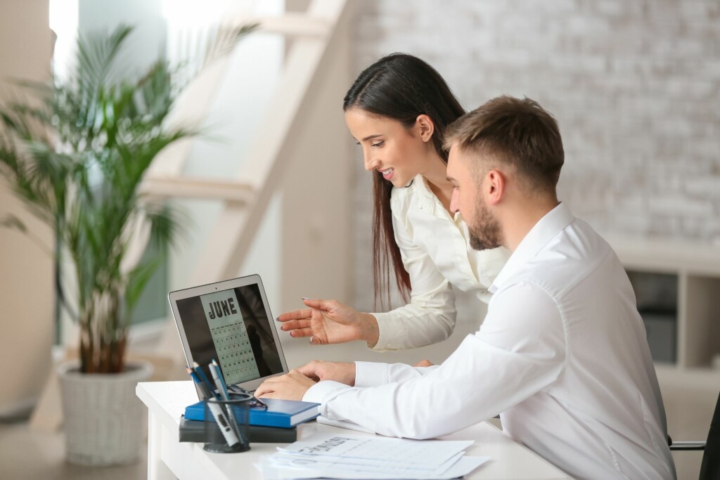 Two employees working on a calendar together