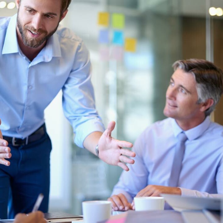 An executive assistant speaks with his coworkers about big picture thinking.