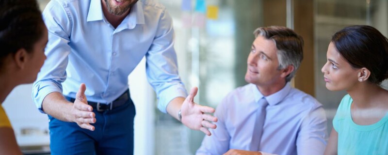 An executive assistant speaks with his coworkers about big picture thinking.