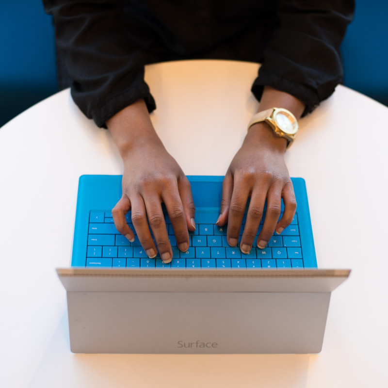 admin typing on laptop with blue keys