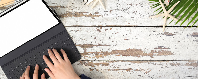 executive assistant typing on a small laptop