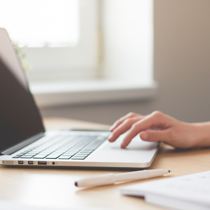administrative assistant starting up their laptop