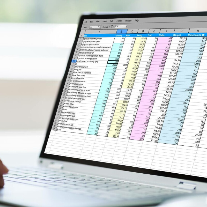 A laptop displaying the COUNT function in Excel.