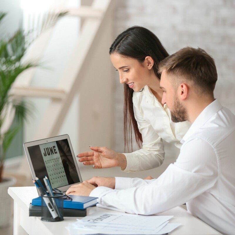 executive assistant showing his calendar to his boss