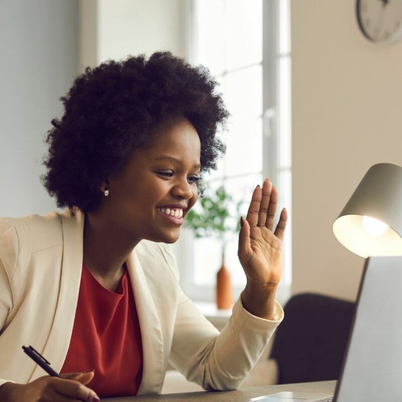 Lady in a virtual work meeting taking minutes notes