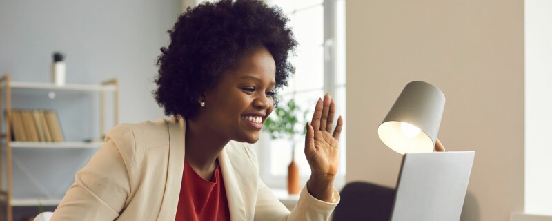 Lady in a virtual work meeting taking minutes notes