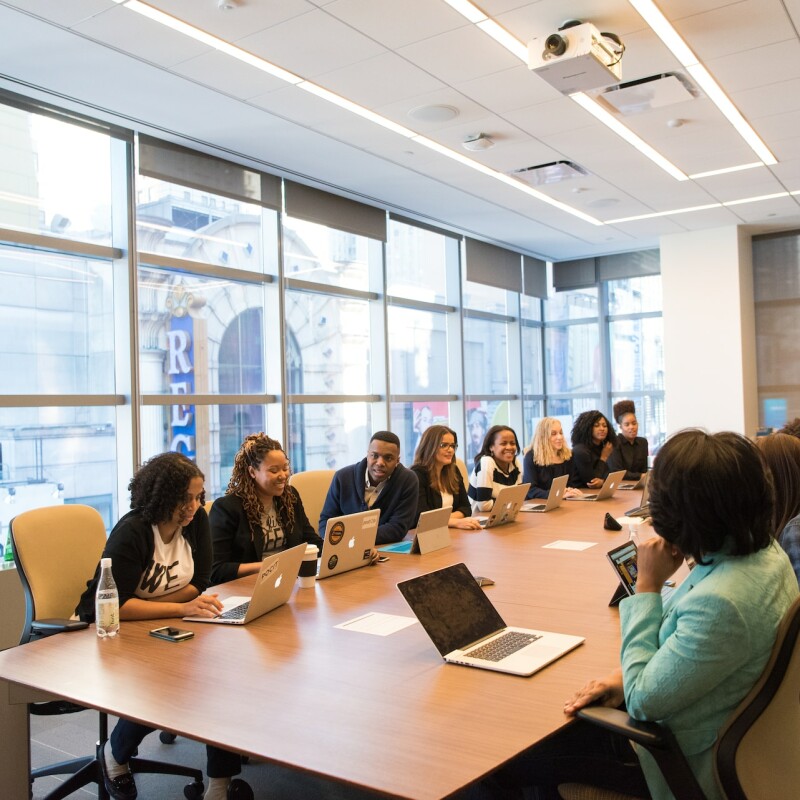 The Board of Directors gathering around a meeting table discussing important topics.
