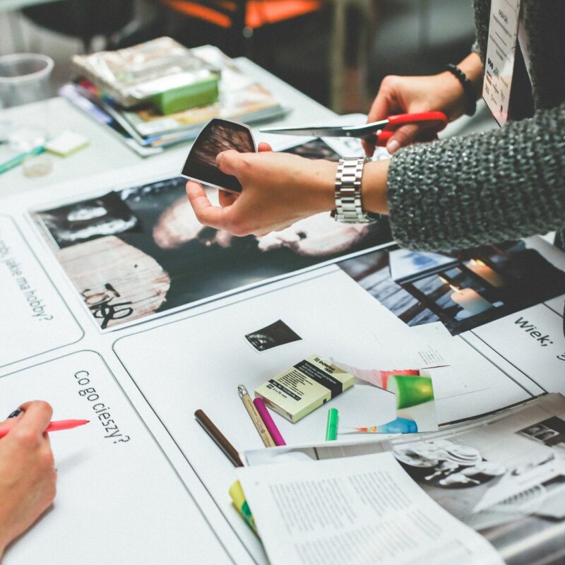 A group of coworkers looking over documents, sheets, graphs, etc. Image demonstrates importance of nourishing creativity in the workplace.