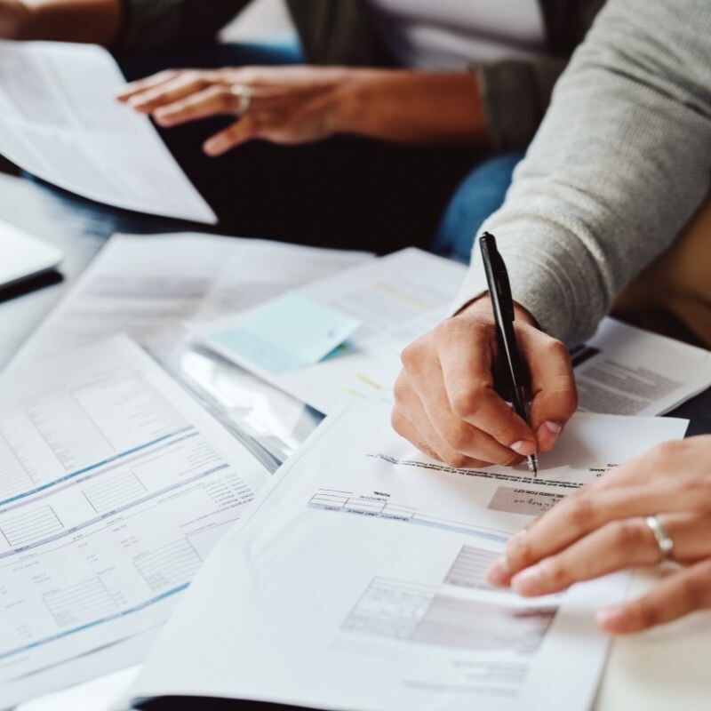 Financial assistant checking and writing papers.