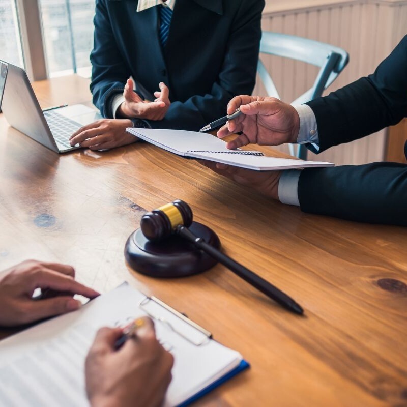 Legal assistant shares meeting agenda with executive.