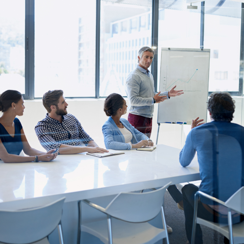Manager speaking to team in meeting.