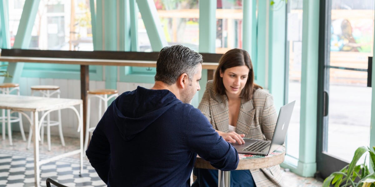 an executive assistant and executive in conversation