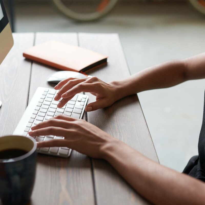 An admin sits at their computer and utilizes project management software to streamline their tasks.