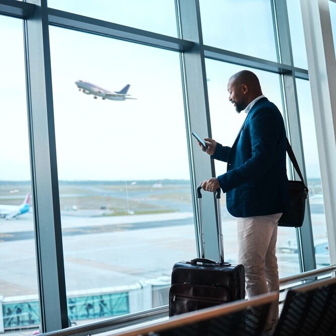 Executive referring to his assistant's travel itinerary on his business trip