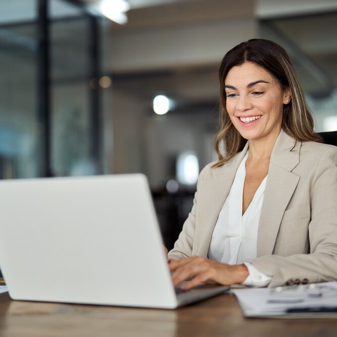 professional woman sitting at laptop