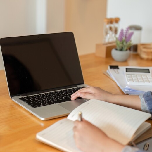 Administrative professional recording her processes and procedures with a toolkit and procedures templates