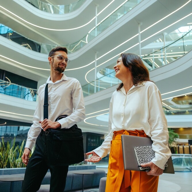 Admin professional discussing growth with colleague