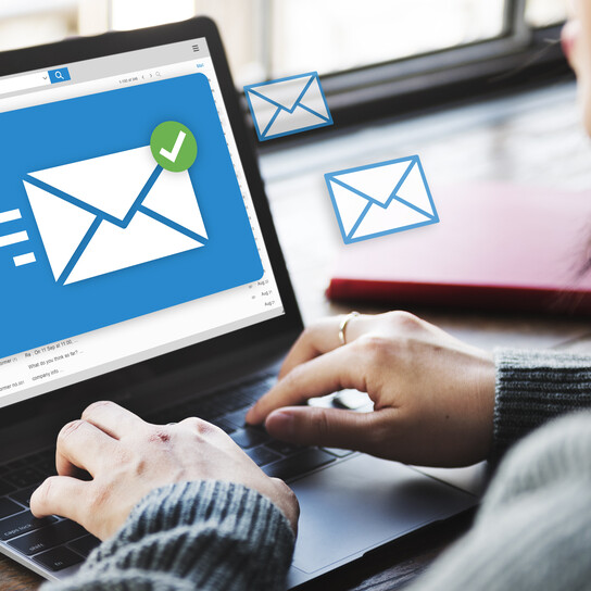 Woman sending emails on laptop