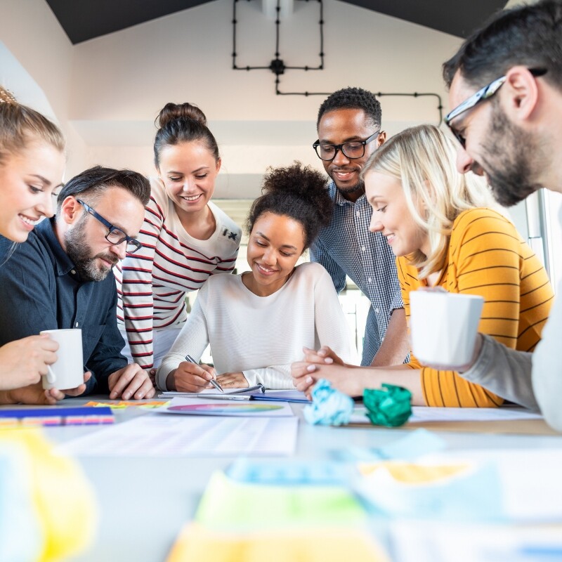 group gathered around a table with coffee and notes
