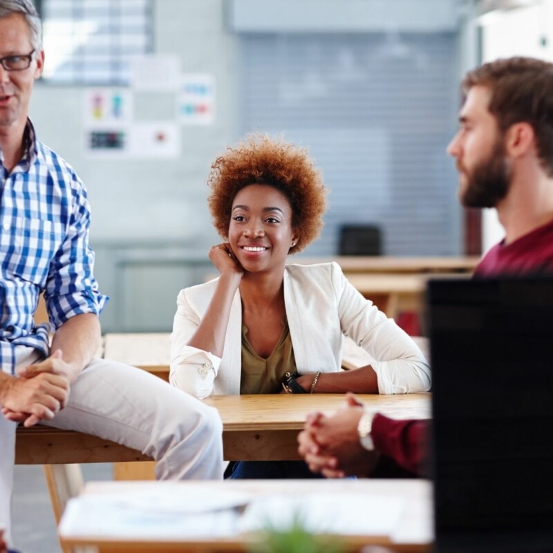 a group of staff working a hybrid schedule in the office