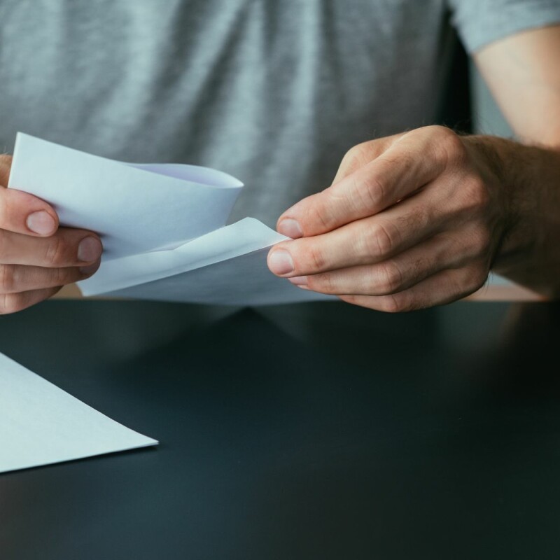 A colleague looks over a written form.