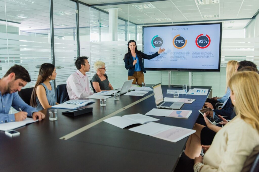 business executive delivering impactful presentation with data visualizations and engaged audience