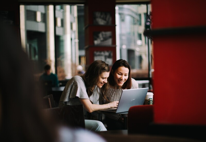 assistants working on laptop together
