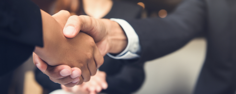 Two colleagues shaking hands after a successful negotiation