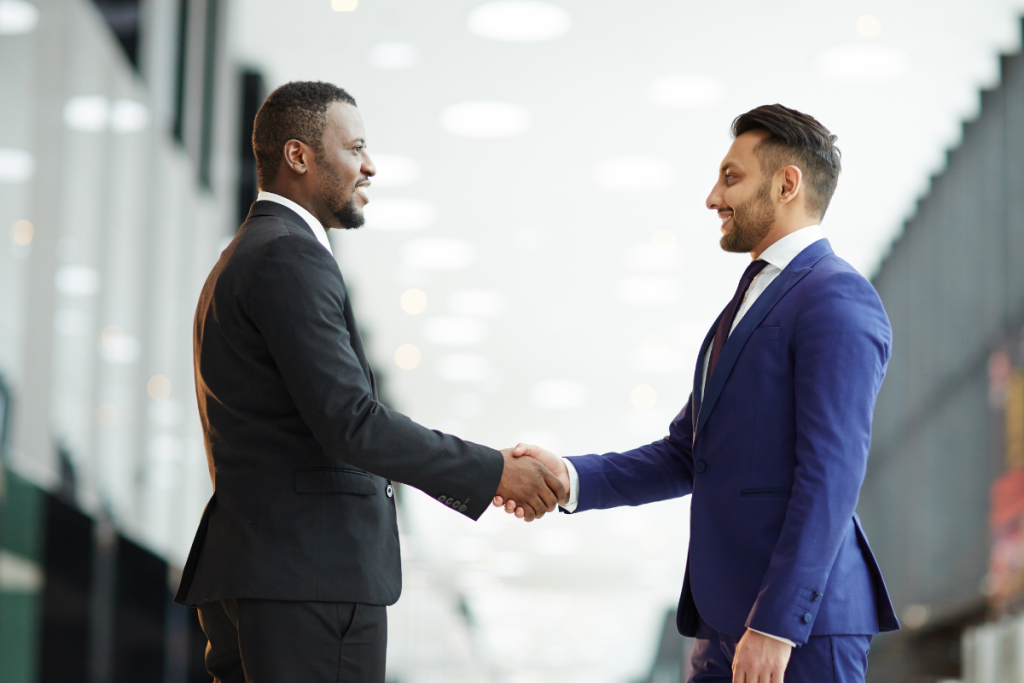 Professionals networking & shaking hands.
