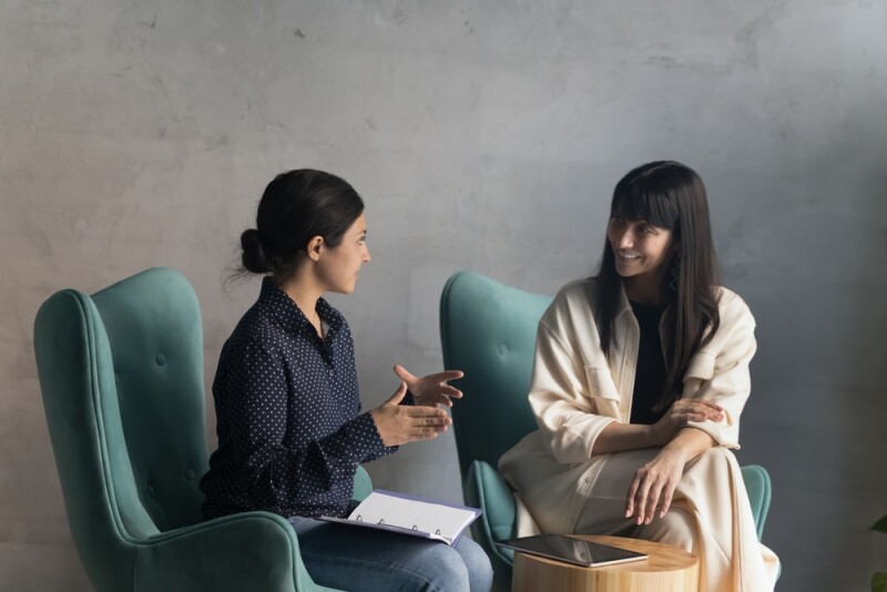 Two female admins talking about career development