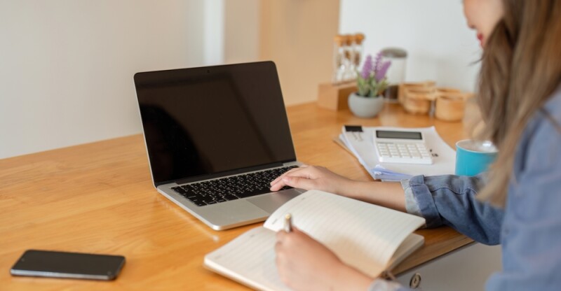 Administrative professional recording her processes and procedures with a toolkit and procedures templates