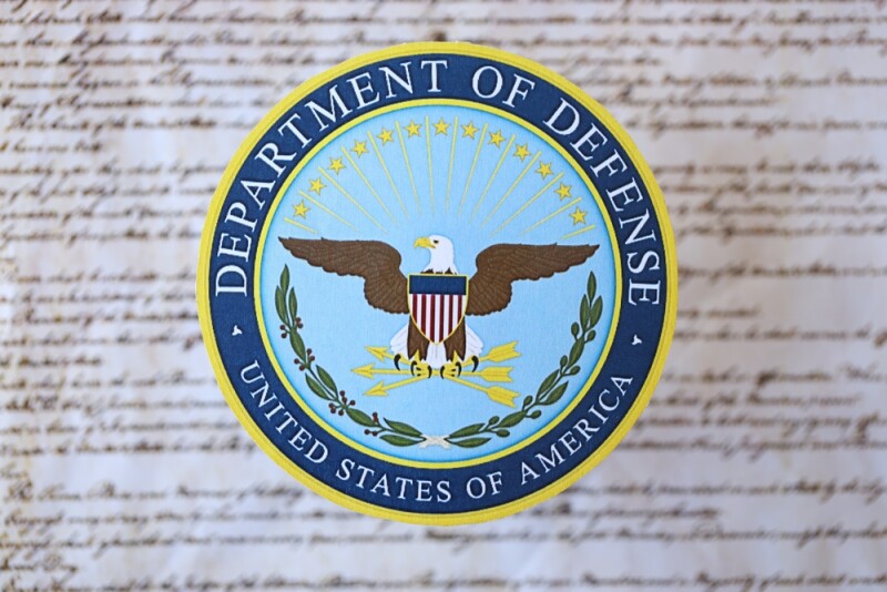 US Department of Defense seal on United States Constitution close up