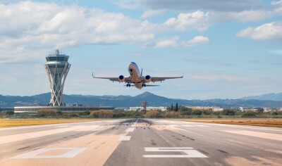 White Passenger plane fly up over take-off runway from airport