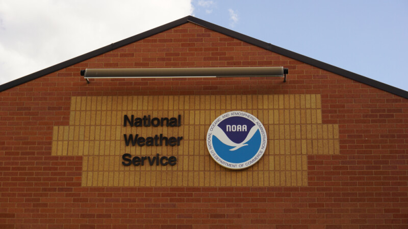 National Weather Service (NWS) sign on brick building.