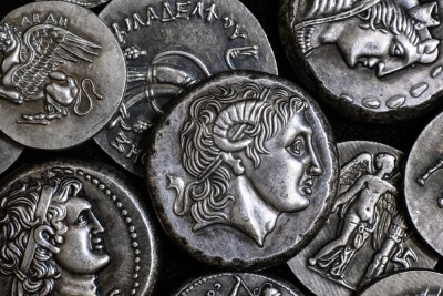 Ancient Greek coin with Alexander the Great portrait, pattern of silver tetradrachms. Top view of old vintage metal money with man face. Concept of Greece, texture, collection, art and history.