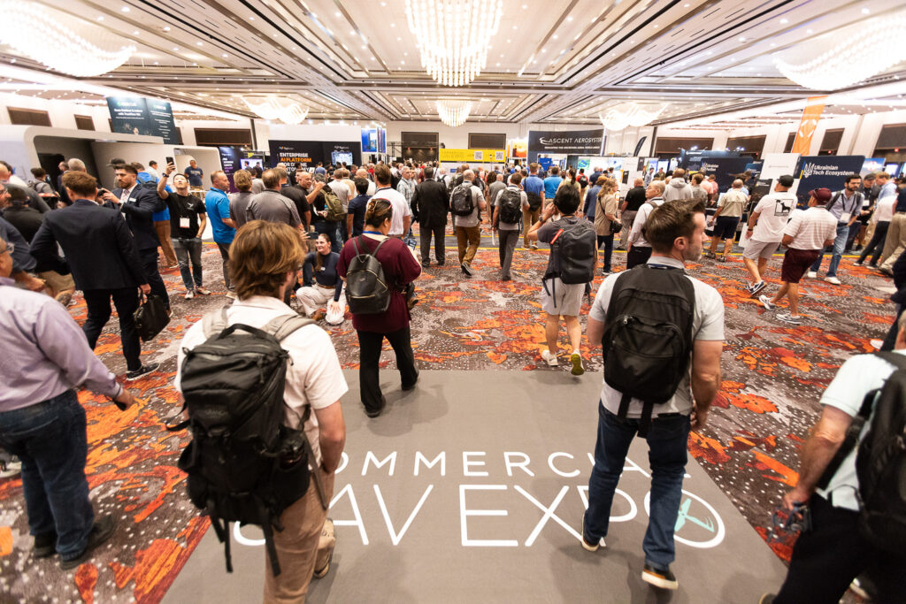 Crowd walking into the exhibit hall floor at Commercial UAV Expo 2025