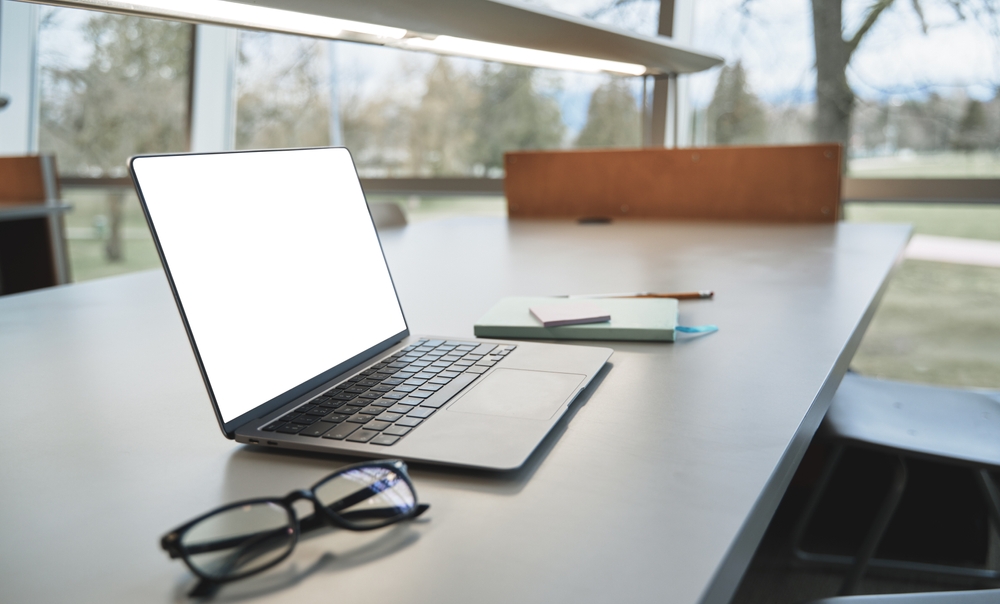 Open laptop on work table, modern computer technology device on desk in office, coworking or university for elearning, online job, digital software, websites ads, workspace background.