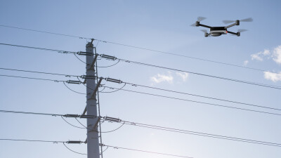 Drone flying in front of powerlines