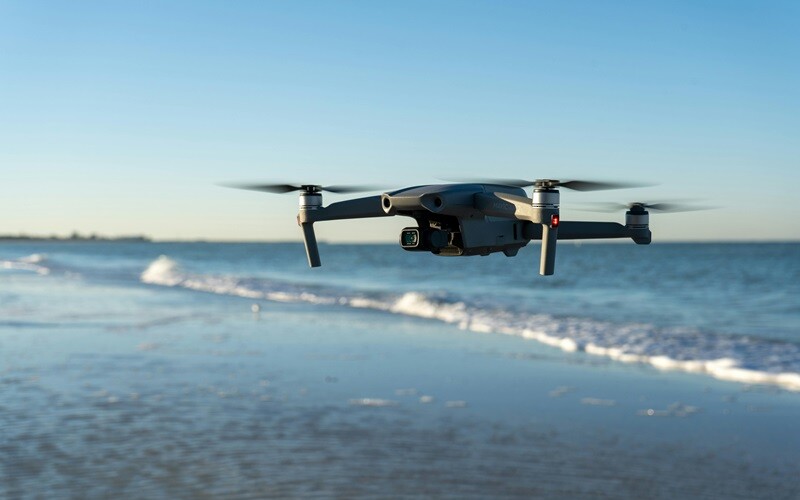 drone flying along a beach