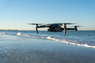 drone flying along a beach