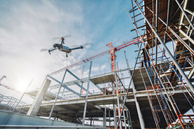 Drone over construction site. video surveillance or industrial inspection	