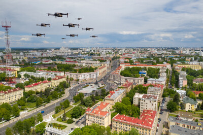 Drones fly over a residential city. Urban landscape with drones flying over it, quadrocopters.