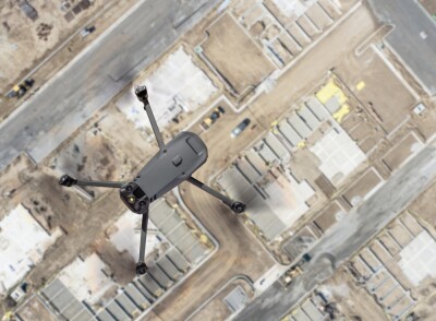 Unmanned Aircraft System Quadcopter Drone UAV In The Air Over Construction Site.