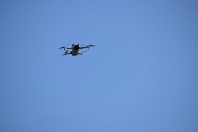 A UAV flying against a clear sky backdrop
