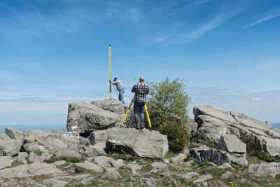 The surveyor measures the top of the mountain