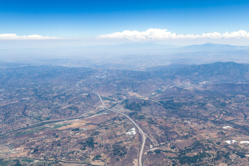 Desert landscape and a smog layer at the distance viewed from an airplane