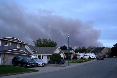 Smoke from a wildfire rise in sky near the city of Kamloops.